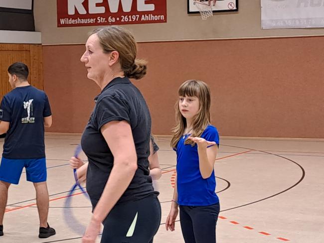 Eltern, die gemeinsam mit ihren Kindern Zeit verbringen und Selbstverteidigung lernen.